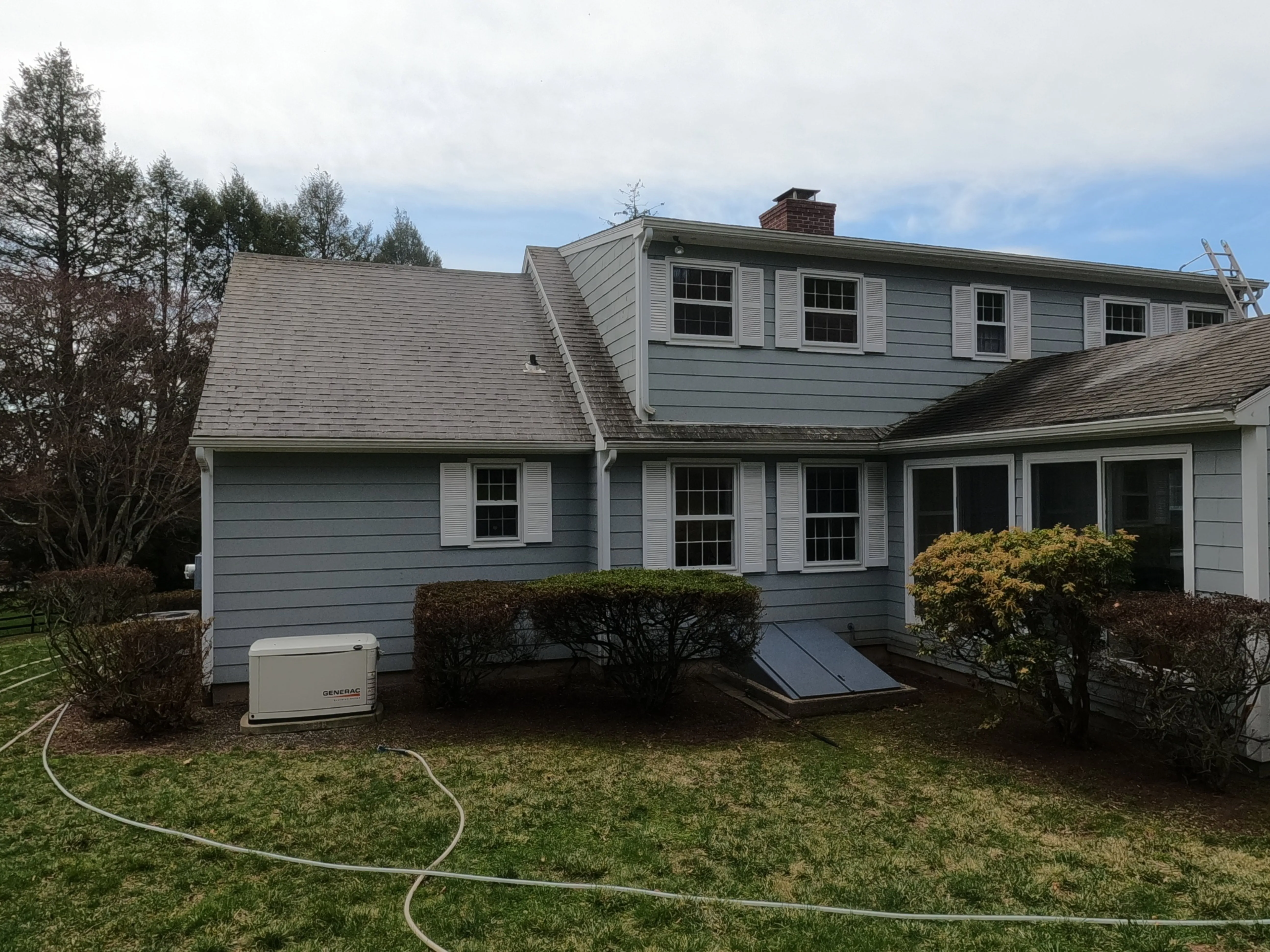 Roof cleaning / roof washing with professional exterior cleaning pressure washer for a curb appeal.